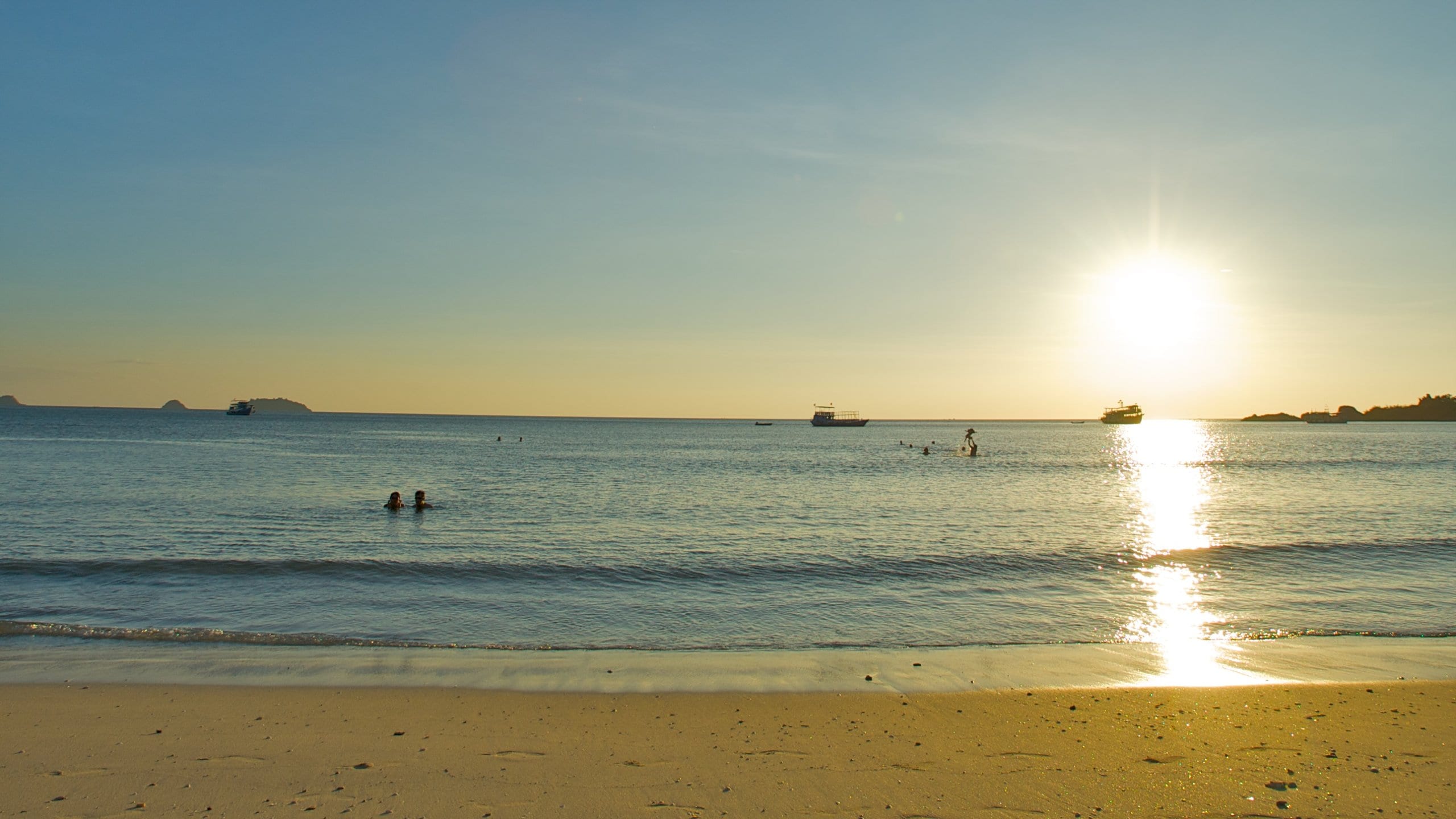 Thailand featuring swimming, a beach and a sunset