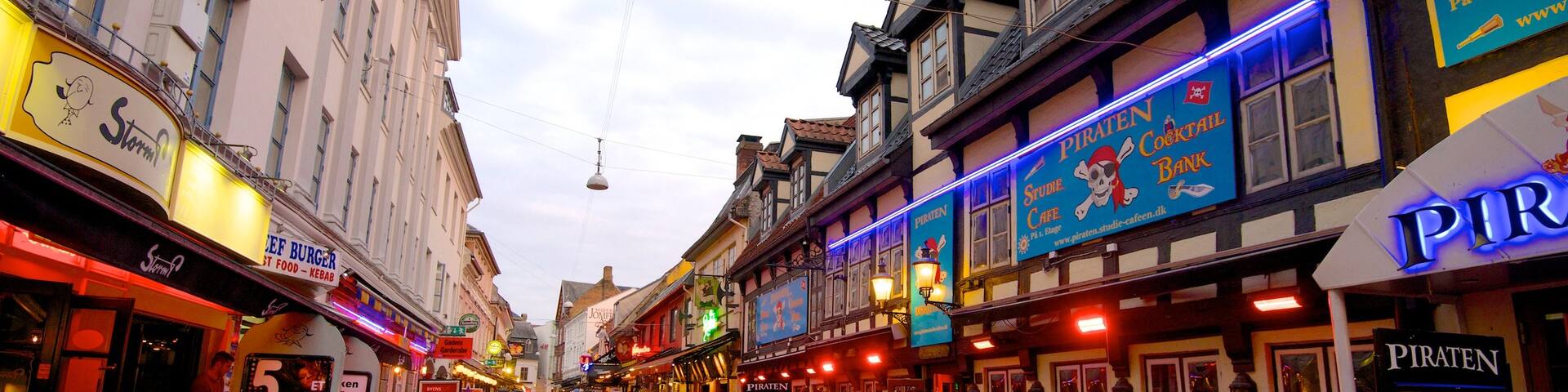 Jomfru Ane Gade showing heritage architecture, outdoor eating and signage