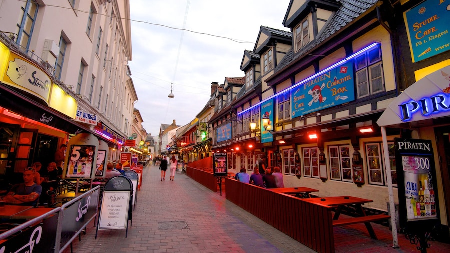 Jomfru Ane Gade showing outdoor eating, heritage architecture and signage