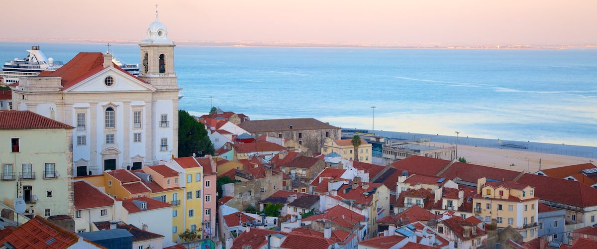 Alfama featuring a coastal town and a sunset