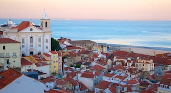 Alfama featuring a coastal town and a sunset