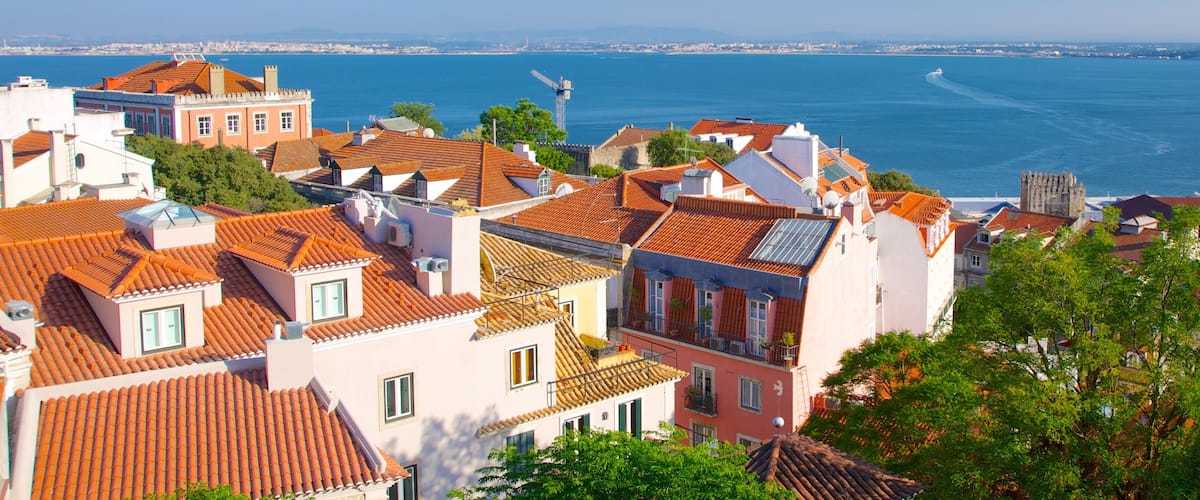 Castle of Sao Jorge featuring a coastal town and heritage architecture