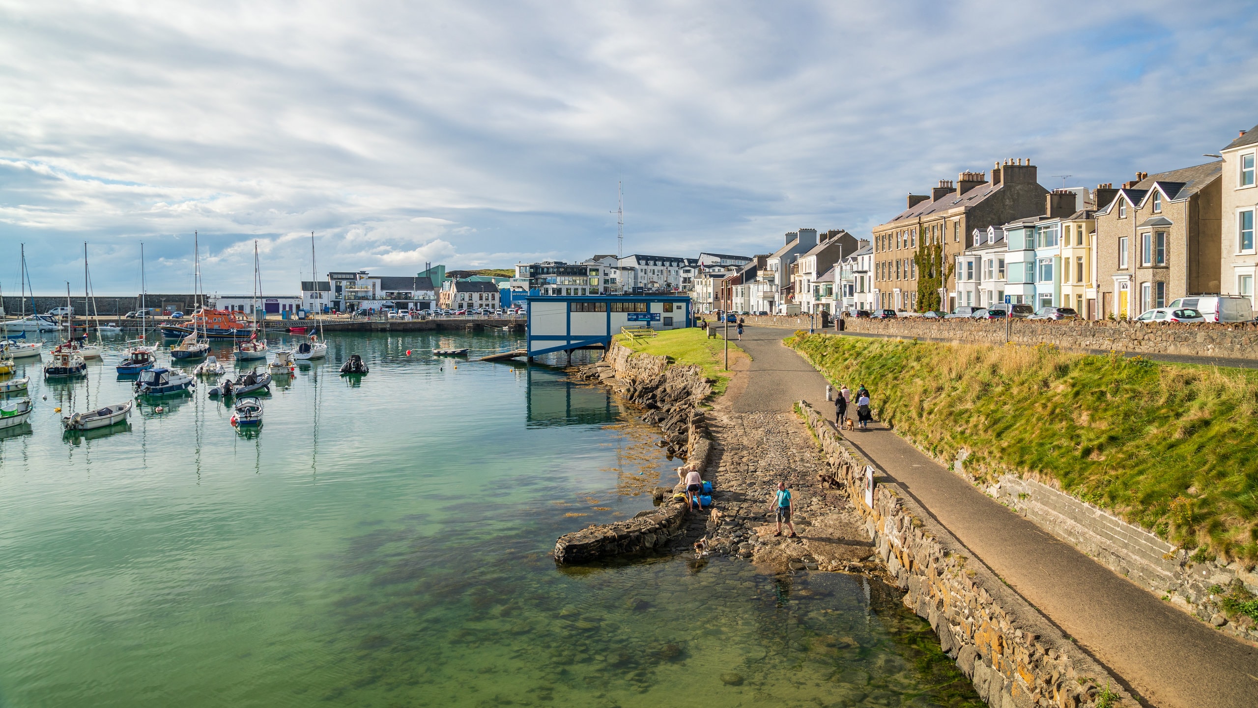 Portrush showing a bay or harbor and a coastal town