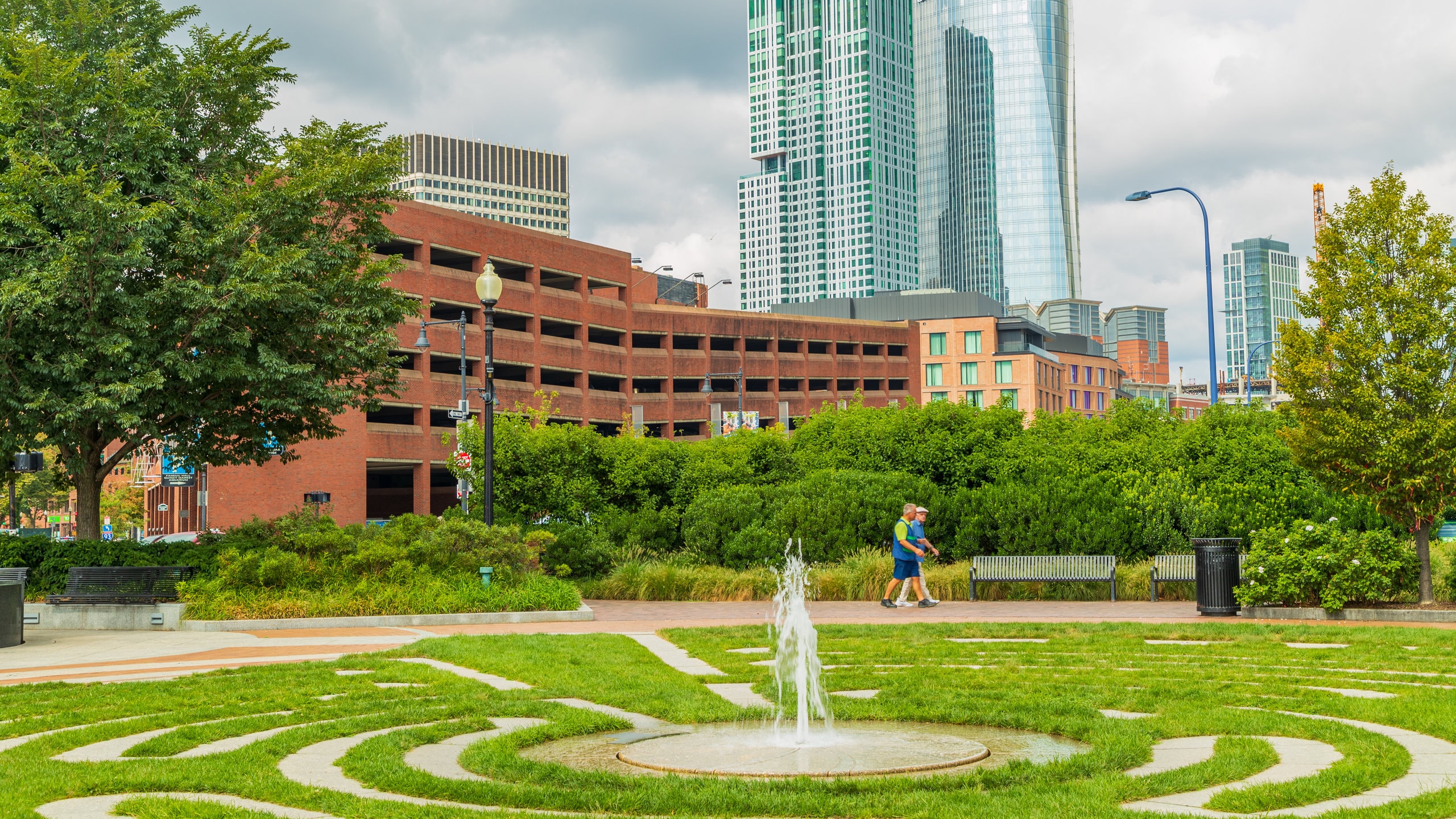 Boston showing a garden and a fountain as well as a couple