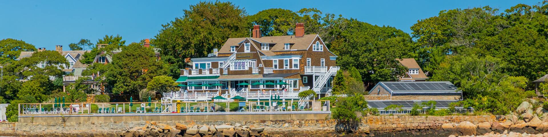 Eastern Point Lighthouse featuring a house, general coastal views and a bay or harbor