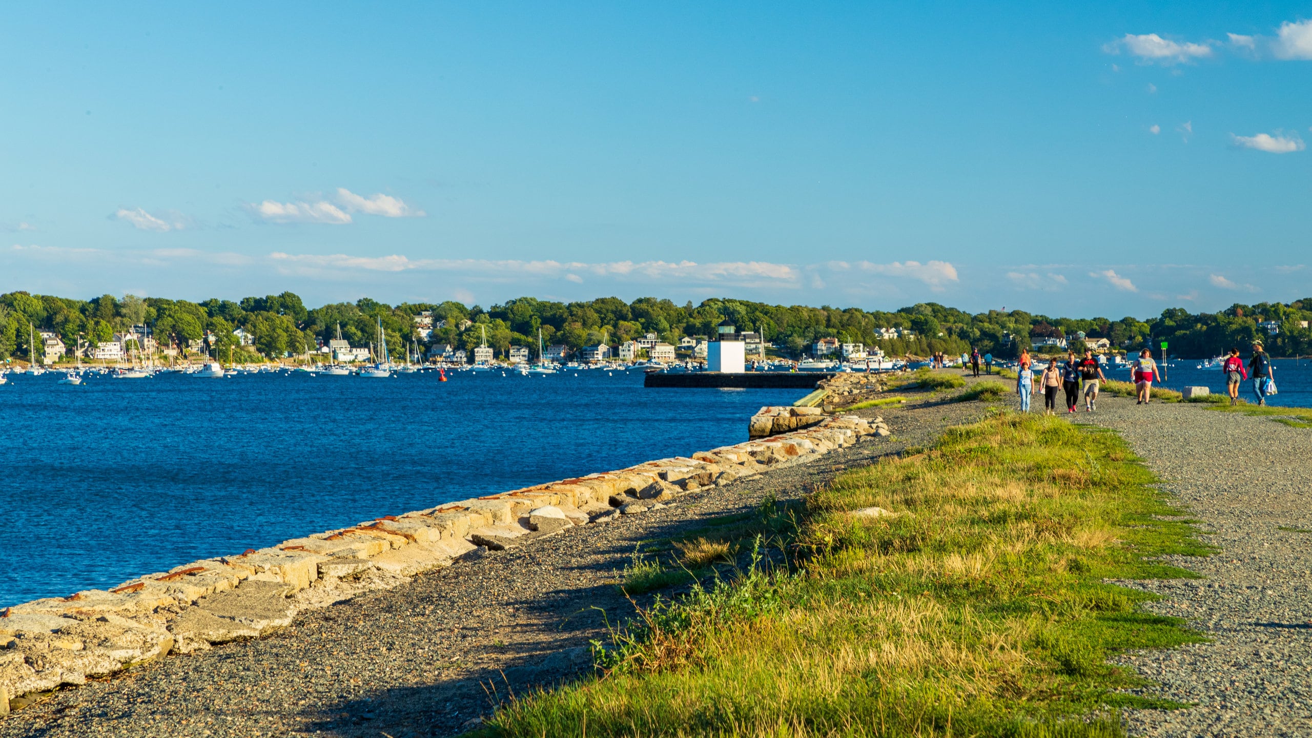 Salem featuring a bay or harbor and a park as well as a small group of people