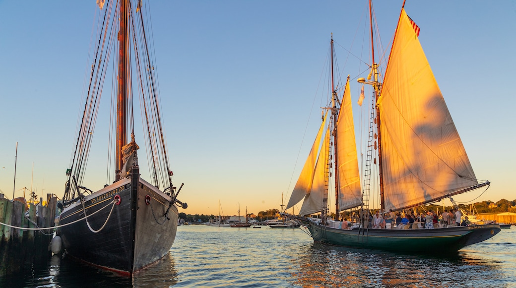 Maritime Gloucester which includes sailing and a sunset as well as a small group of people