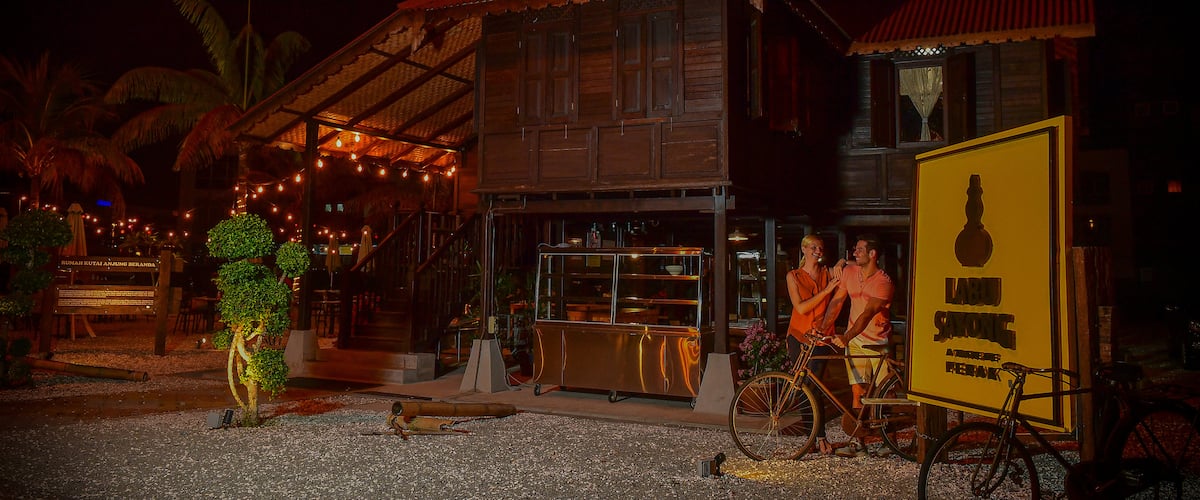 Ipoh showing night scenes and signage as well as a couple