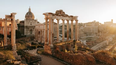 Roman Forum which includes a ruin, heritage elements and a sunset