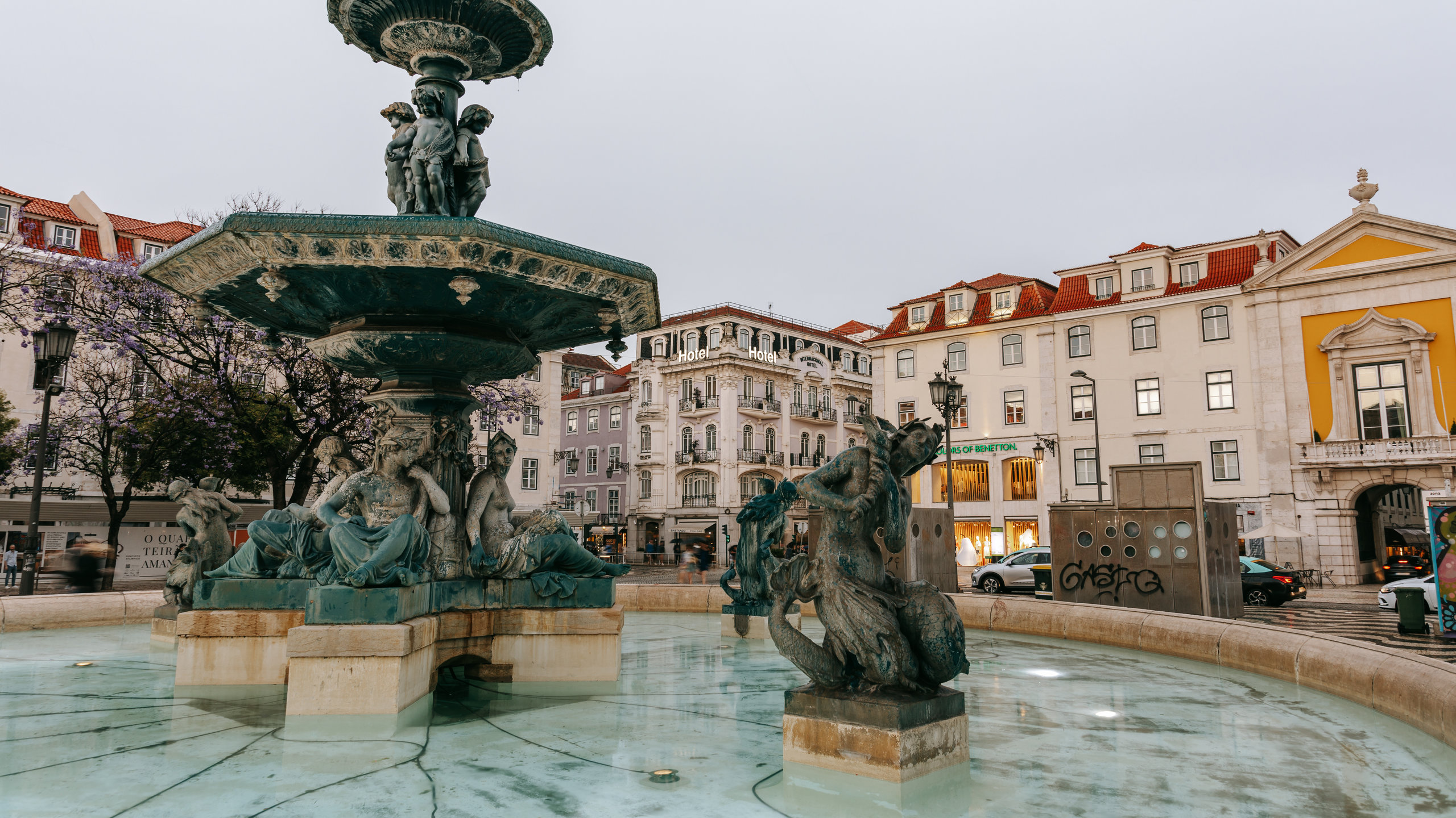 Rossio Square featuring a fountain and a statue or sculpture