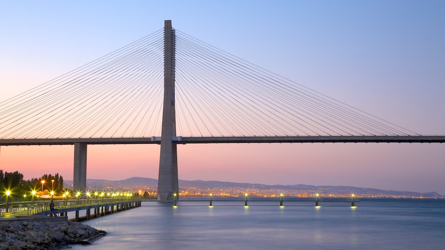 Vasco da Gama Bridge featuring a bridge, a sunset and modern architecture