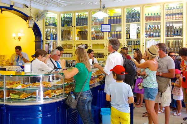 Pasteis de Belem which includes interior views and café lifestyle as well as a large group of people