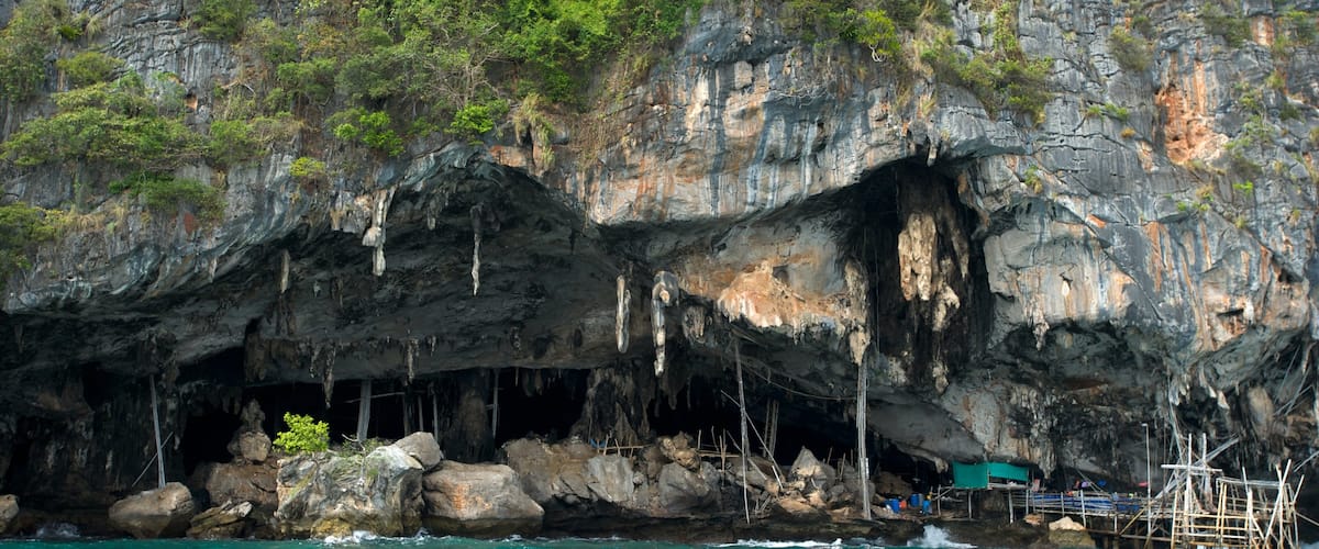 Maya Bay featuring rugged coastline, caves and a bay or harbour