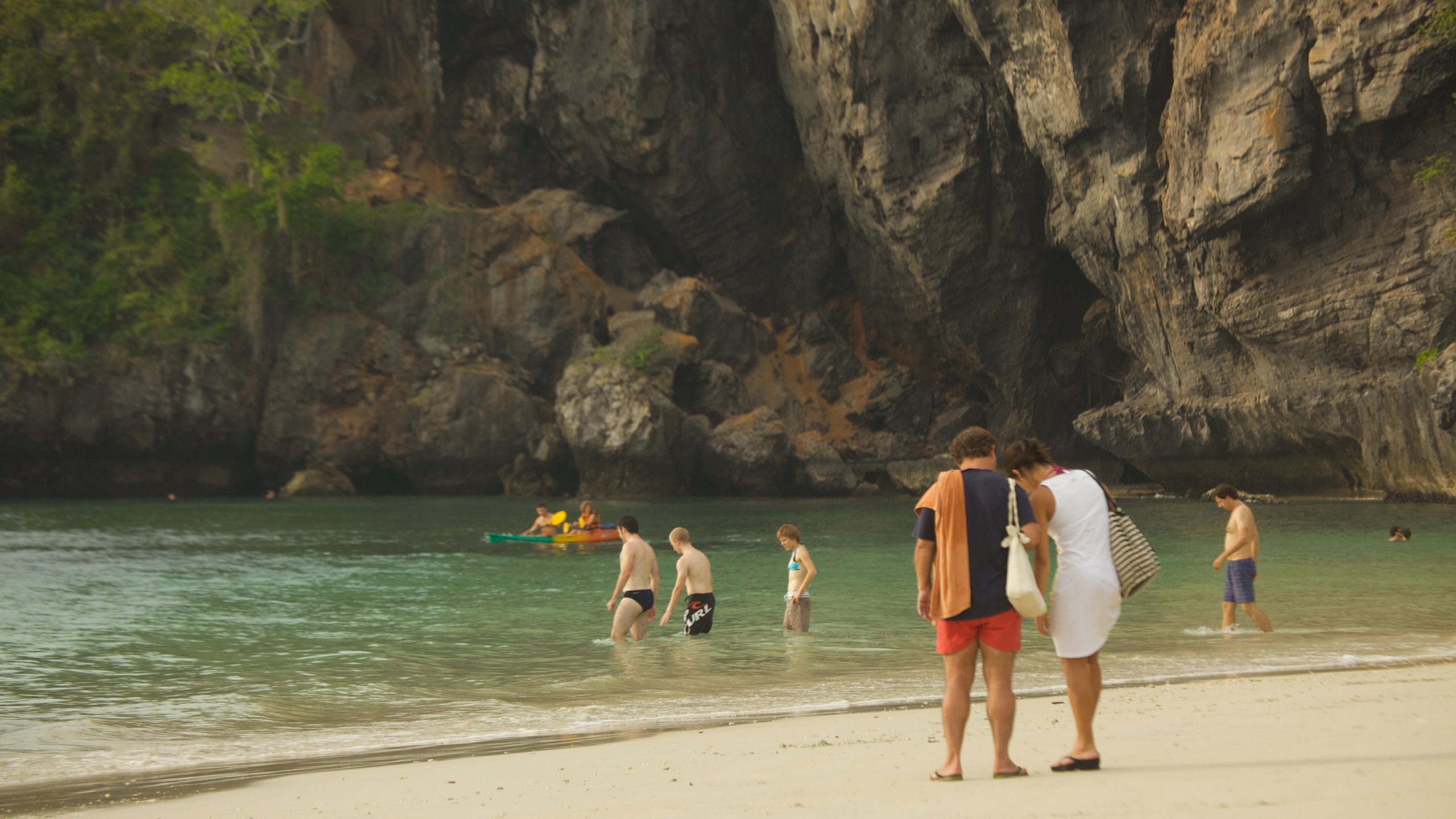 West Railay Beach showing a sandy beach, rugged coastline and swimming