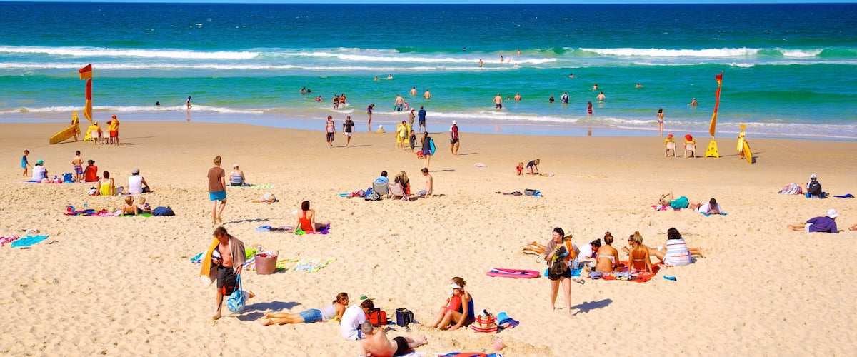 Southport which includes a sandy beach, swimming and tropical scenes
