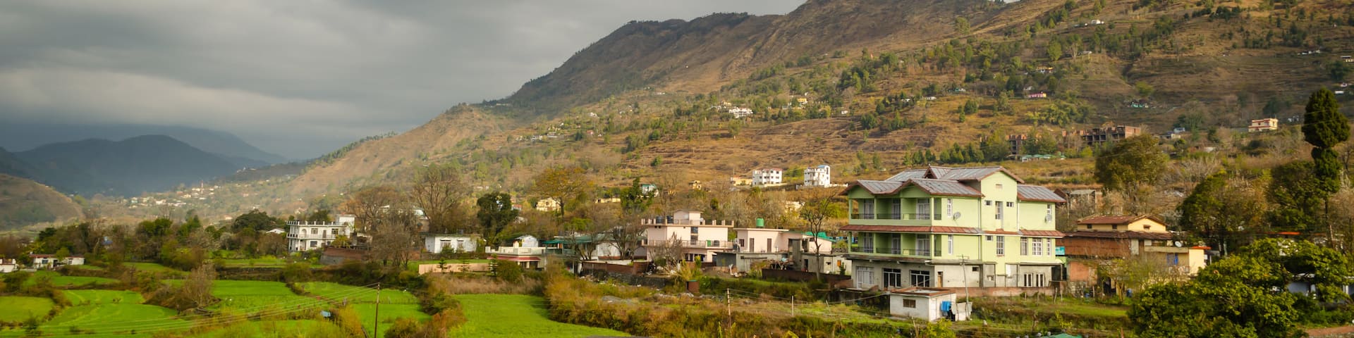 Naukuchiyatal which includes farmland and a small town or village