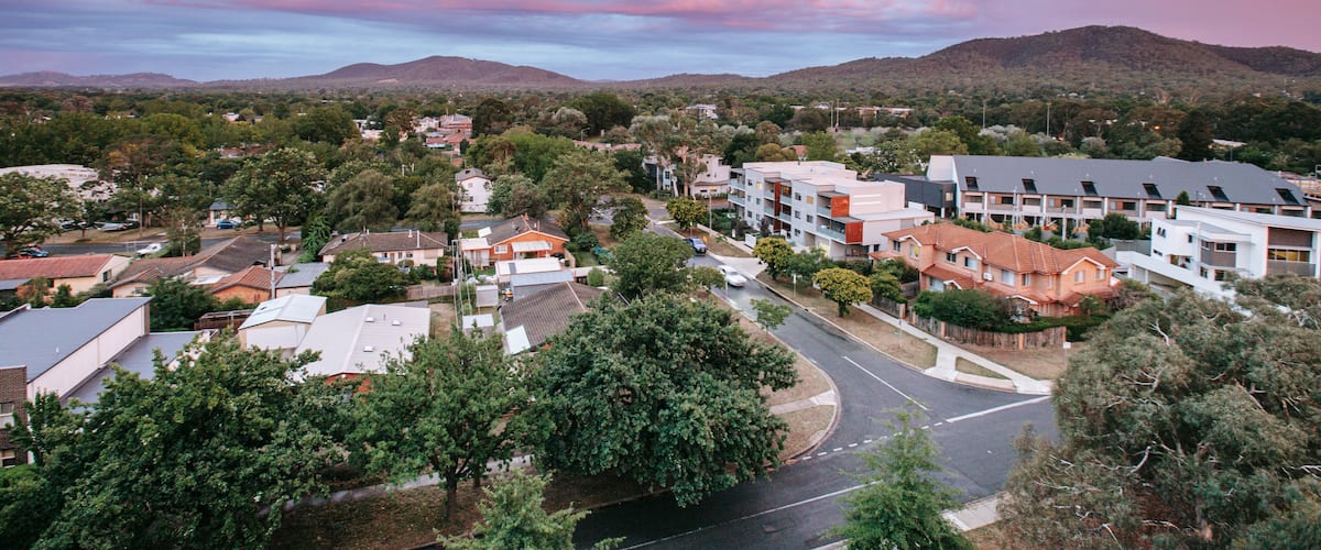 Braddon showing landscape views, a sunset and a small town or village