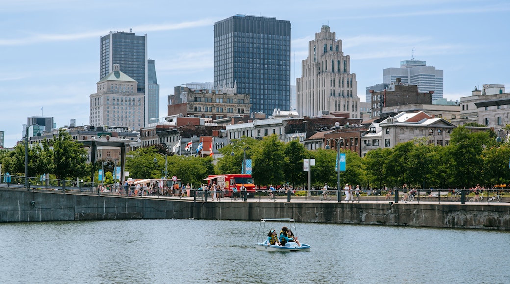 Old Montreal showing a river or creek, boating and a city
