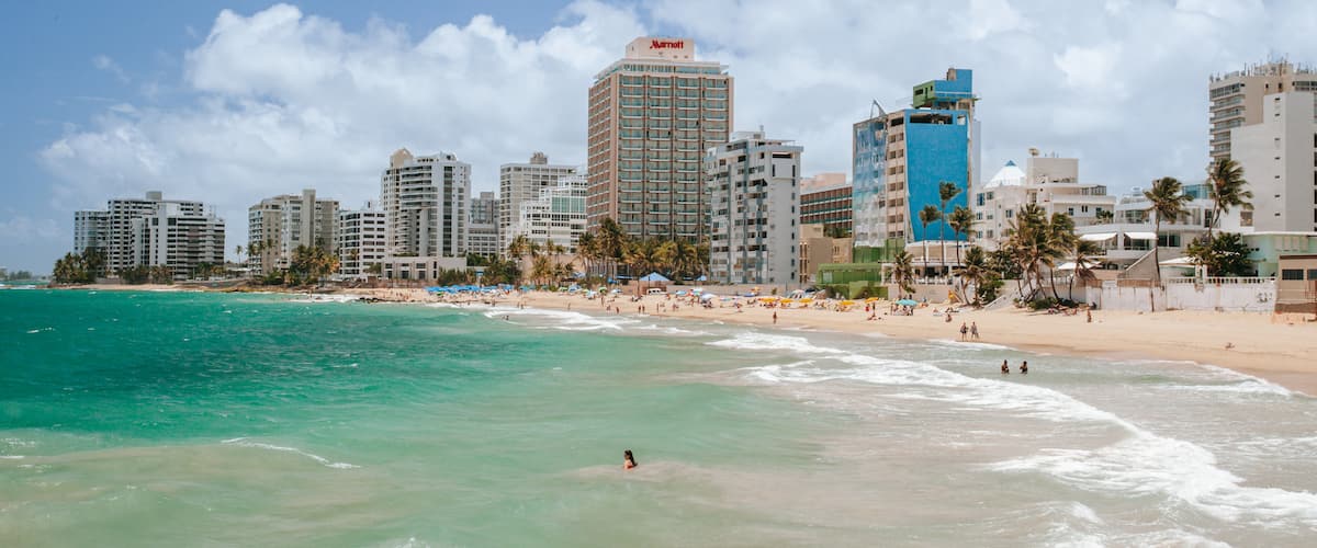 Condado Beach which includes general coastal views and a coastal town