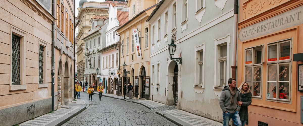 Mala Strana which includes street scenes and a city as well as a couple
