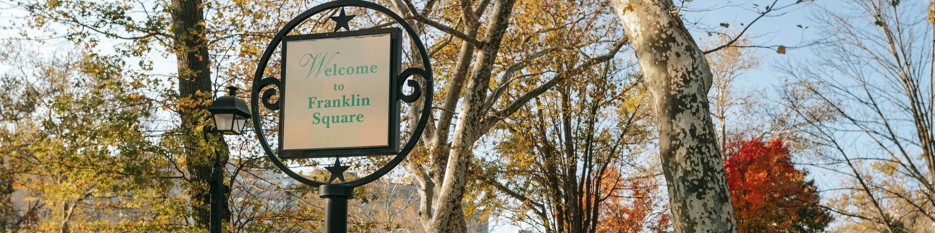 Center City showing signage, fall colors and a garden