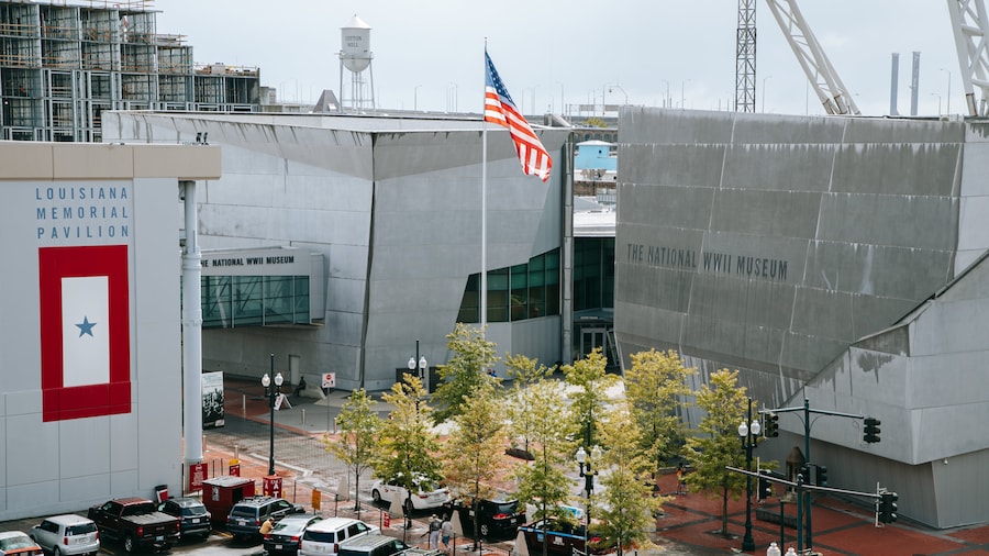 Exterior view of the National WWII Museum in New Orleans, featuring modern architecture and American flag.