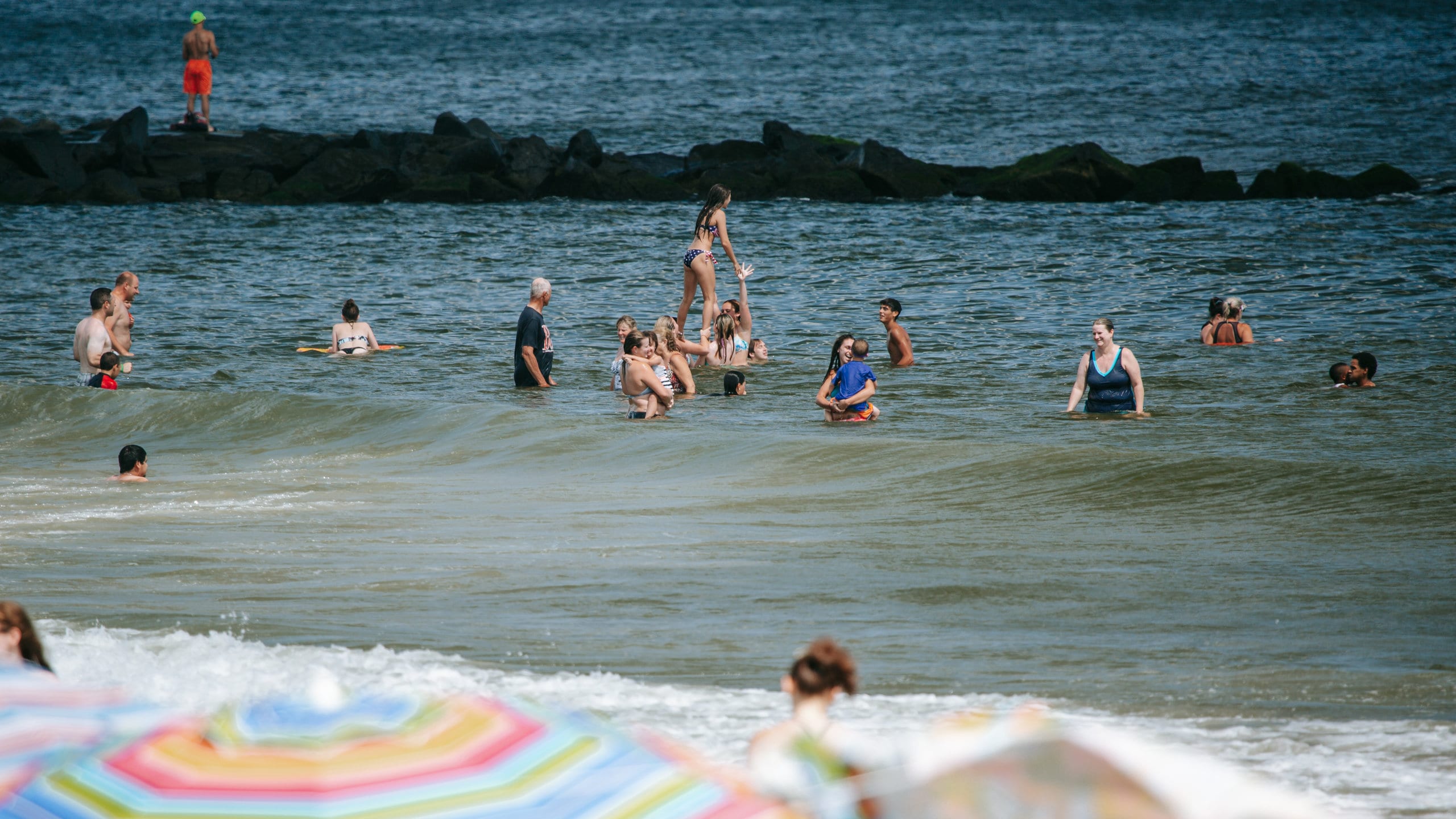 Ocean City featuring general coastal views and swimming as well as a small group of people