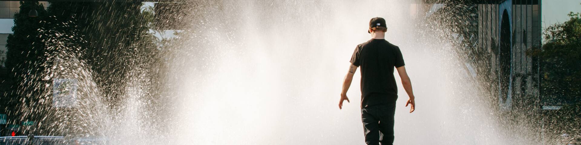 Salmon Street Springs which includes a fountain as well as an individual male