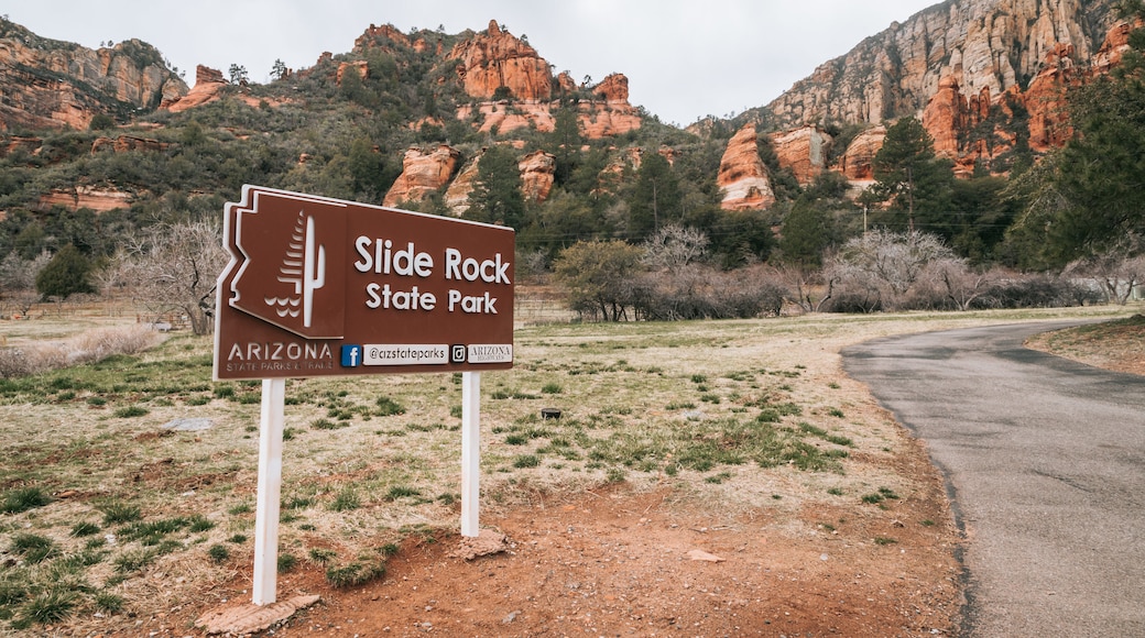 Slide Rock State Park which includes signage and a gorge or canyon