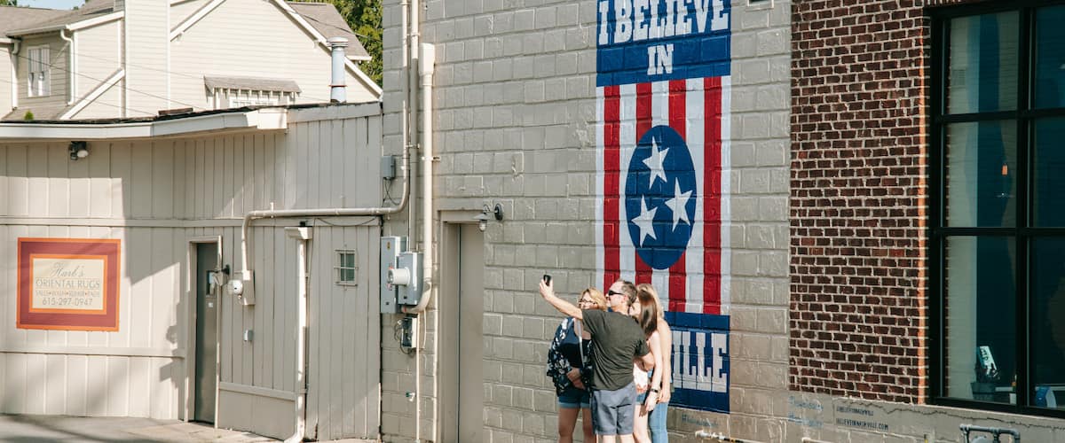 12 South which includes outdoor art and street scenes as well as a small group of people