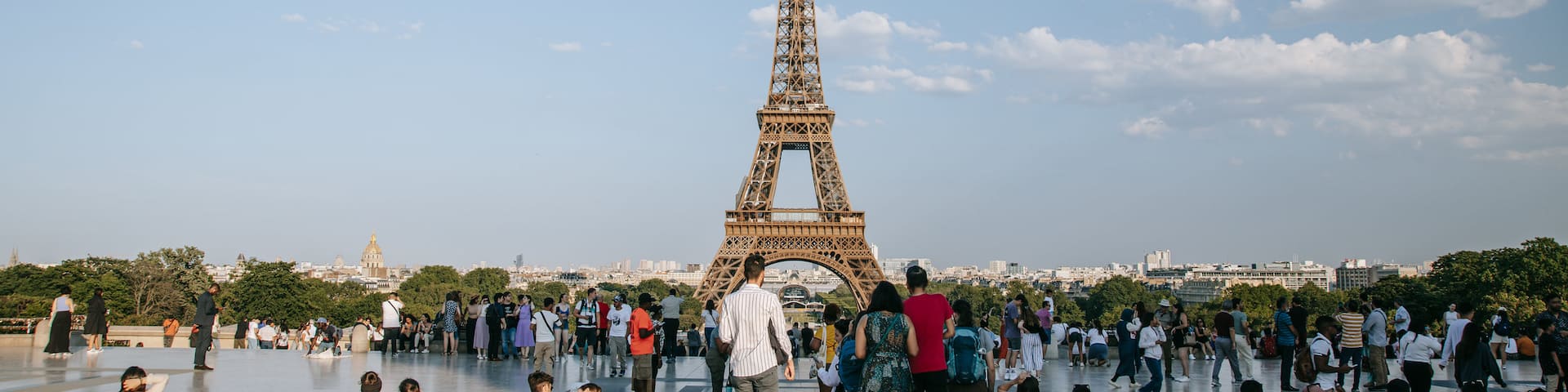 Eiffel Tower featuring a monument as well as a large group of people