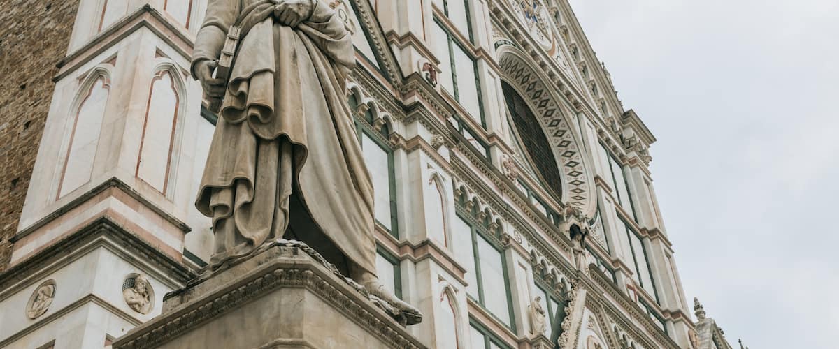 Basilica of Santa Croce showing a statue or sculpture, a church or cathedral and heritage elements