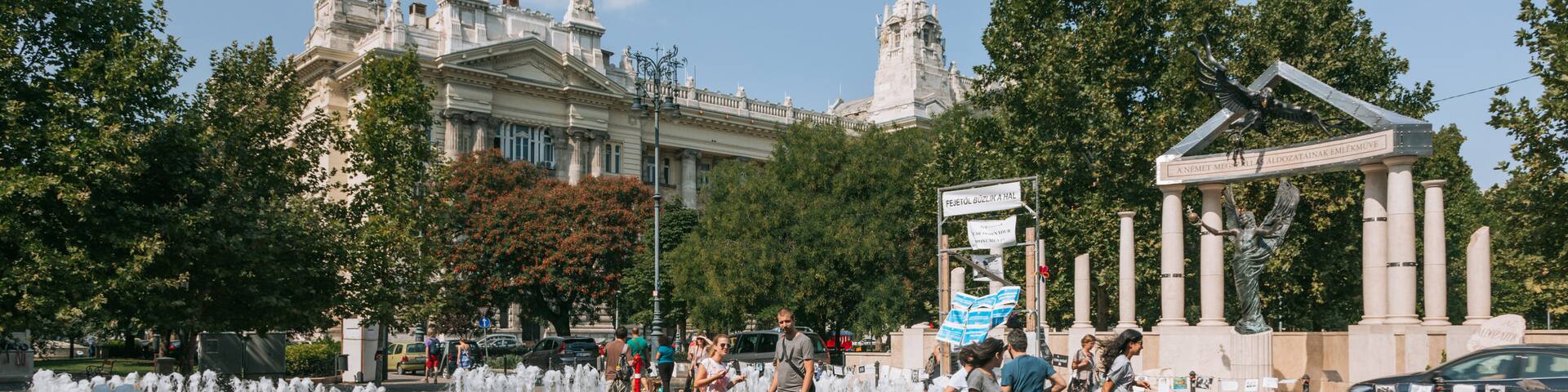 Liberty Square featuring a fountain as well as a small group of people