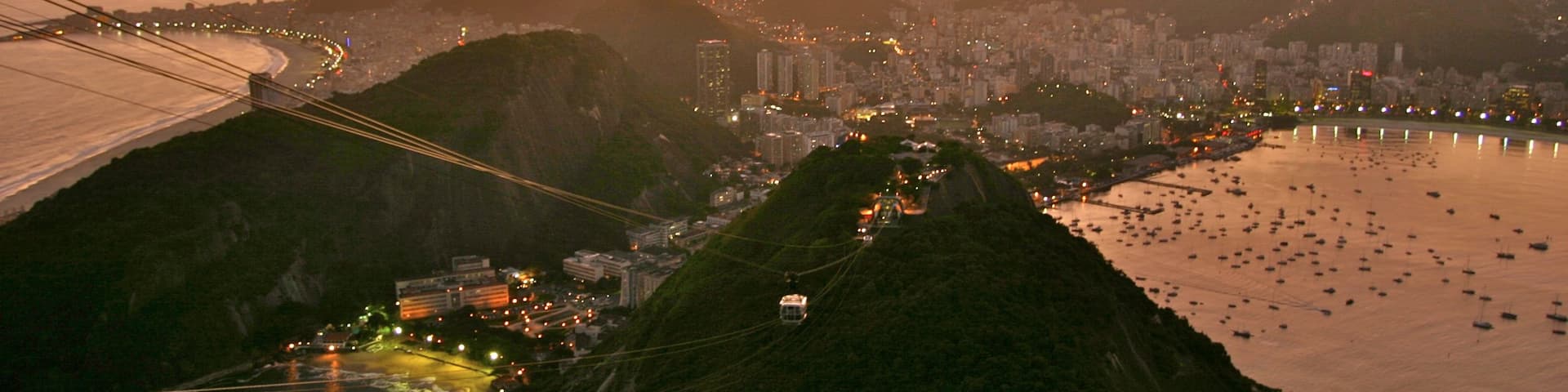 Sugar Loaf Mountain featuring a coastal town, a bay or harbour and a sunset