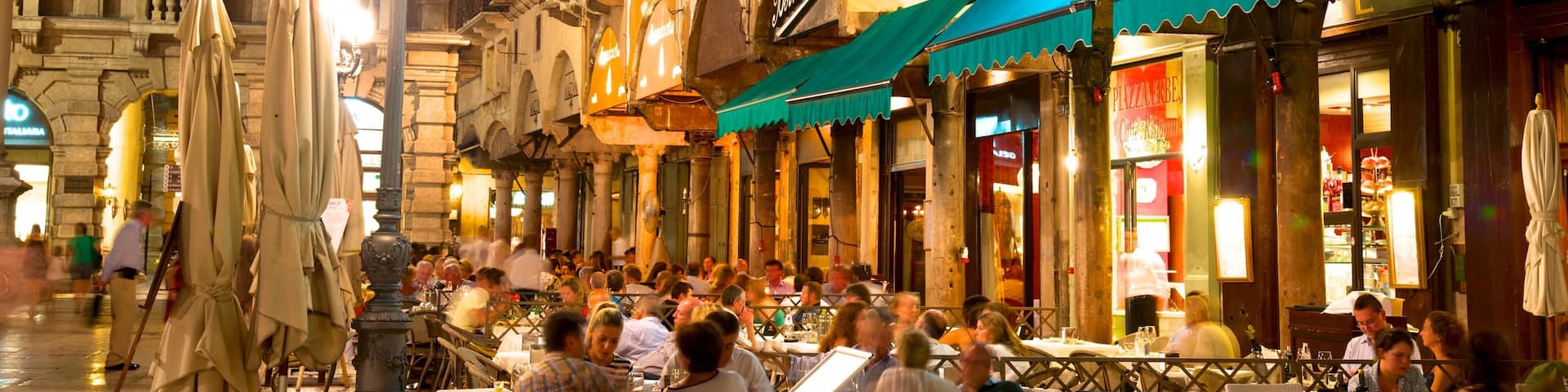 Piazza delle Erbe showing dining out, heritage architecture and a city