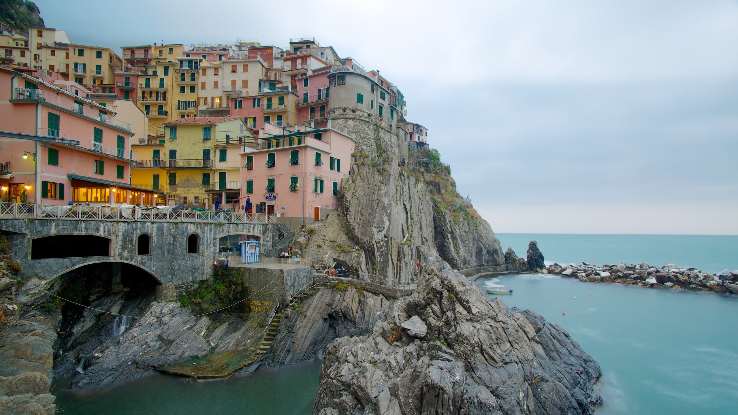 Manarola which includes rocky coastline, night scenes and a coastal town