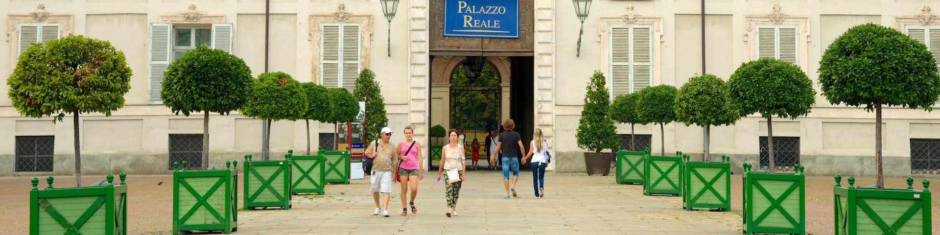 Turin Royal Palace featuring heritage architecture and a castle as well as a small group of people