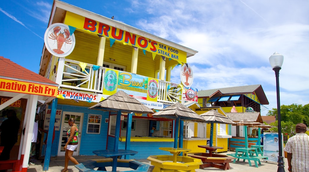 Arawak Cay featuring signage, a coastal town and café scenes