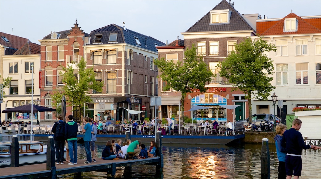 The Hague showing a river or creek as well as a small group of people