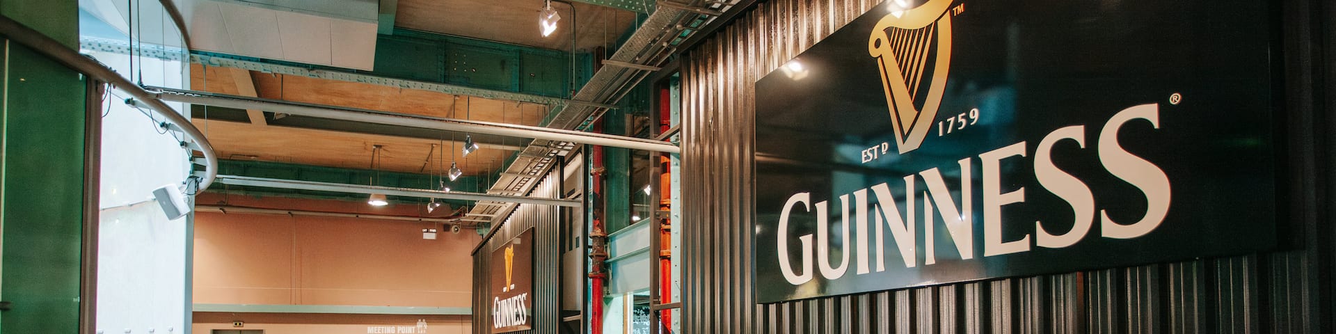 Guinness Storehouse showing signage and interior views as well as a small group of people