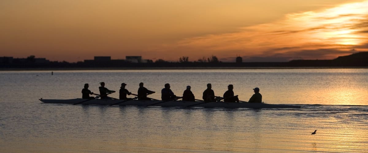 Boulder featuring a sunset and kayaking or canoeing as well as a large group of people