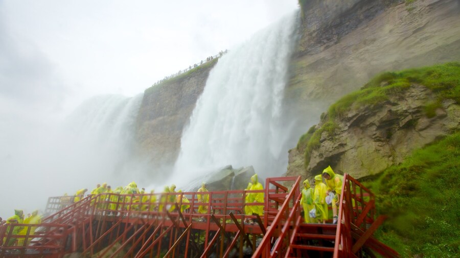 Visitors on wooden walkways near Bridal Veil Falls at Cave of the Winds.