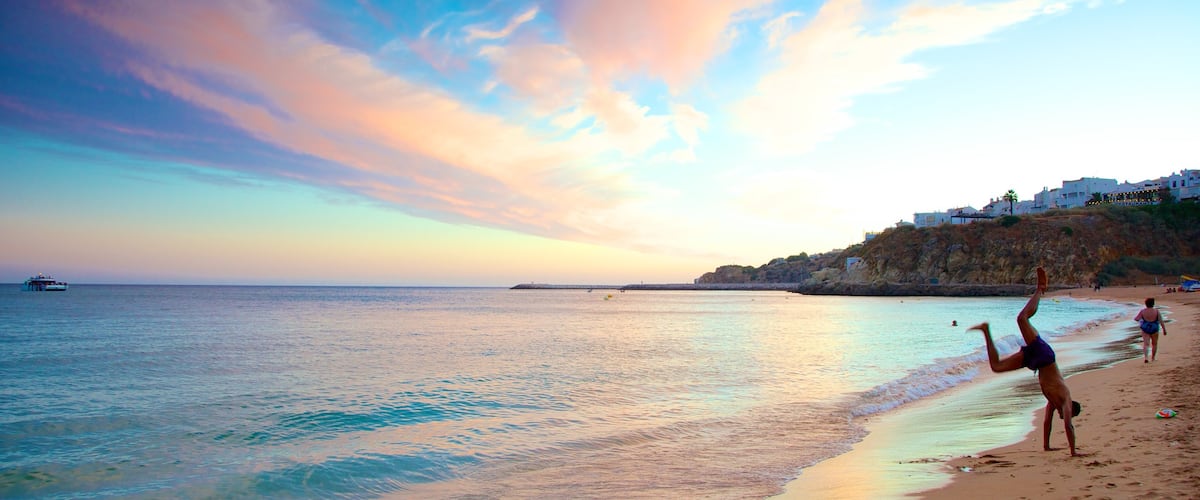 Albufeira which includes a beach and landscape views as well as an individual male
