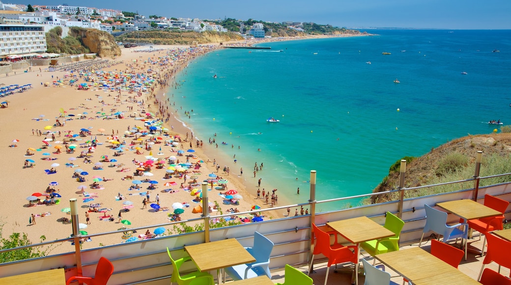 Albufeira showing a coastal town, swimming and a beach