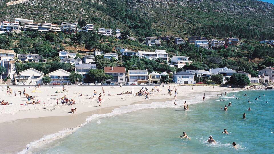 Gordon\'s Bay showing swimming, a coastal town and a sandy beach