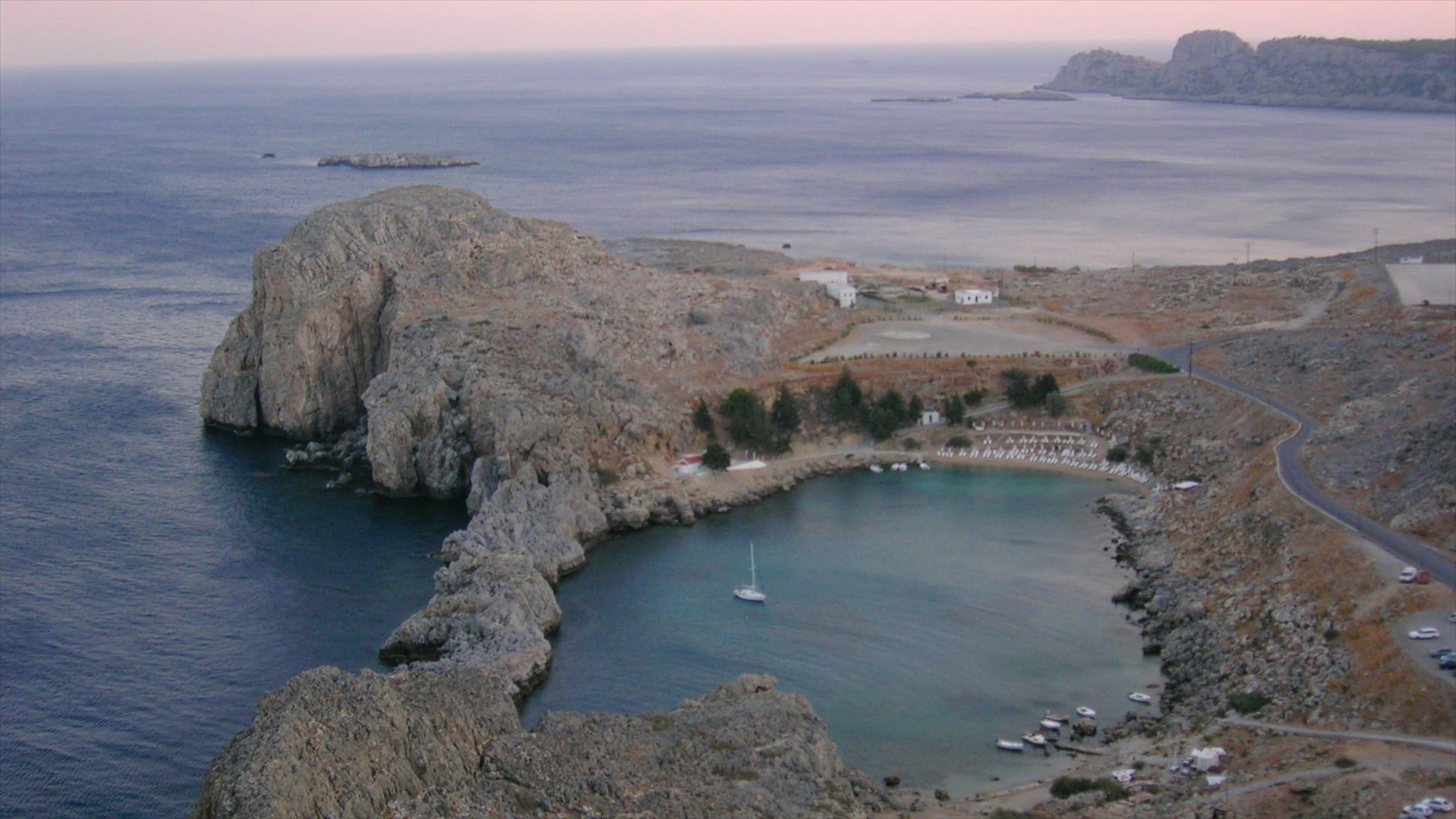 Lindos showing rugged coastline, a bay or harbor and general coastal views