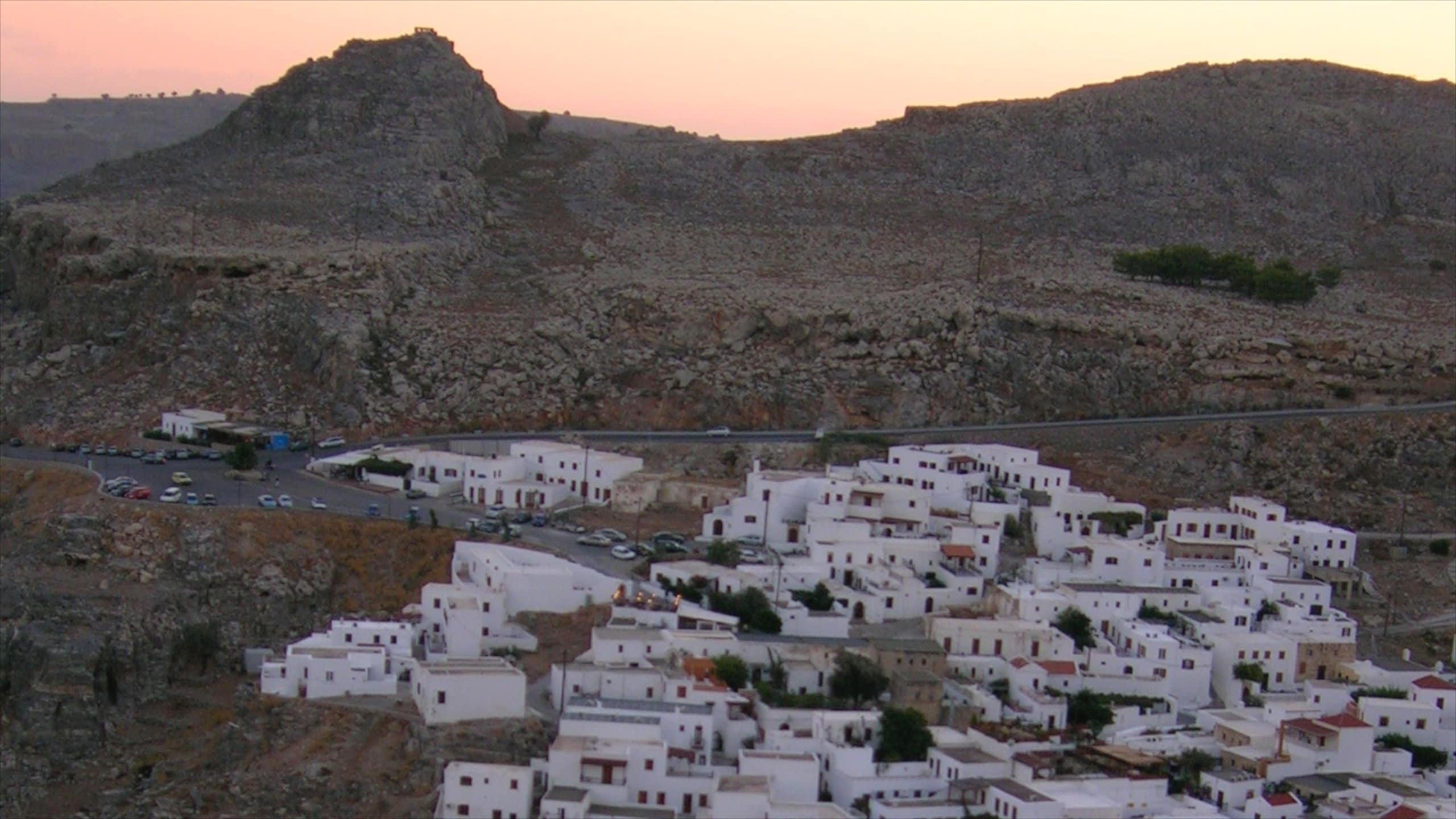 Lindos which includes a small town or village, a sunset and heritage architecture