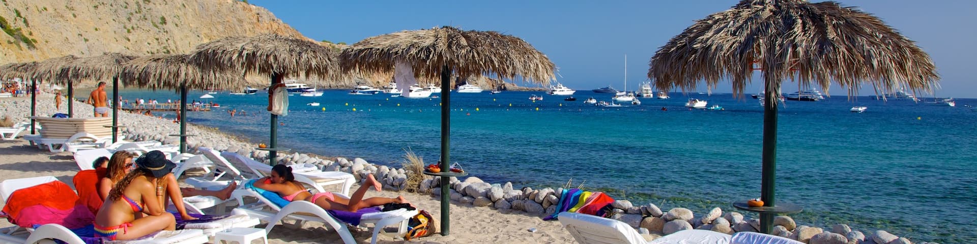 Cala Jondal Beach showing boating, tropical scenes and a beach