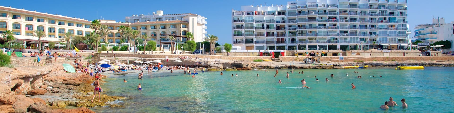Calo des Moro Beach showing a luxury hotel or resort, a coastal town and coral