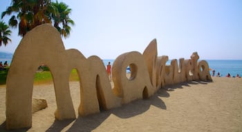 Malagueta Beach showing a sandy beach and signage